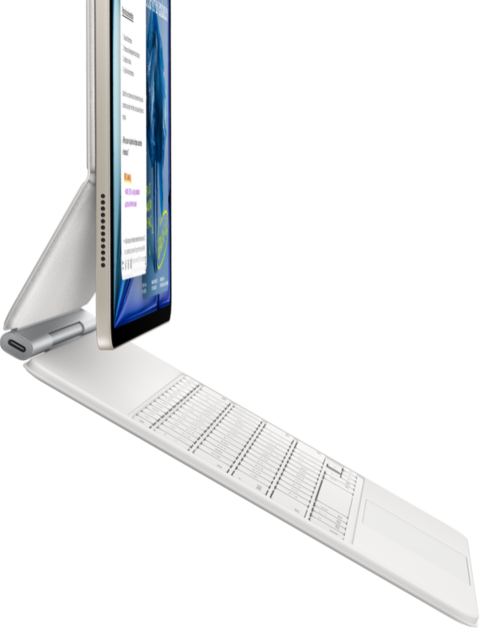 iPad Air, coloris lumière stellaire, fixé à un Magic Keyboard, blanc, vue latérale